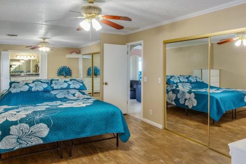 a bedroom with two beds and a ceiling fan at Havasu Coral Sun Pool Garage RV Parking in Lake Havasu City