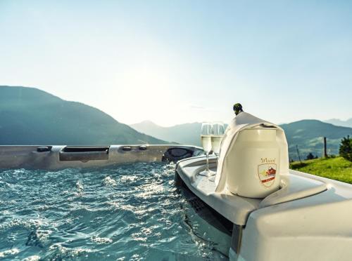 a boat in a body of water at Maierl-Alm & Maierl-Chalets in Kirchberg in Tirol
