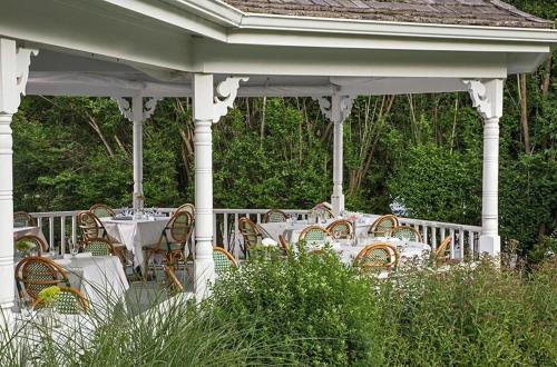 a table and chairs sitting under a gazebo at Shelter Island House in Shelter Island Heights