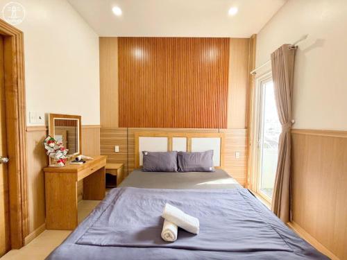 a bedroom with a large bed and a window at Nova Hotel Vũng Tàu in Vung Tau