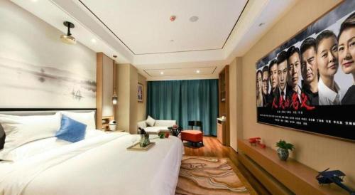 a hotel room with a large movie poster on the wall at East Queen Hotel (Xi'an Beimen Metro Station) in Xi'an