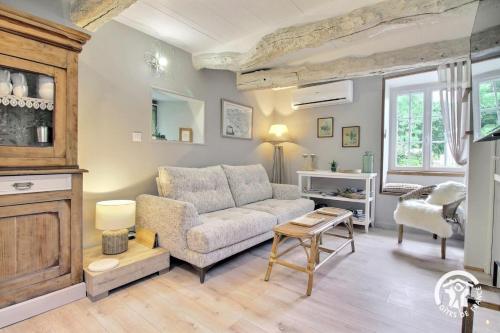 a living room with a couch and a table at La cle des champs in Langonnet