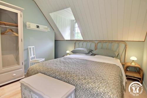 a bedroom with a bed and a window at La cle des champs in Langonnet