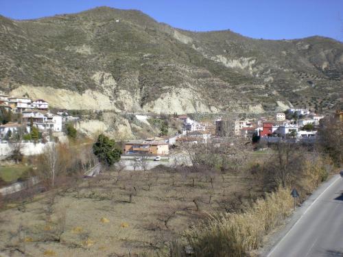 a town on the side of a mountain with a road at Labella María in Pinos Genil