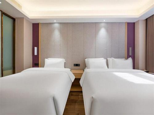 Letto o letti in una camera di Lavande Hotels Jinzhong Youjian Pingyao