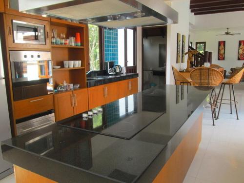 a kitchen with a large black counter top at CM8 Beds & Private Pool in Mae Pim