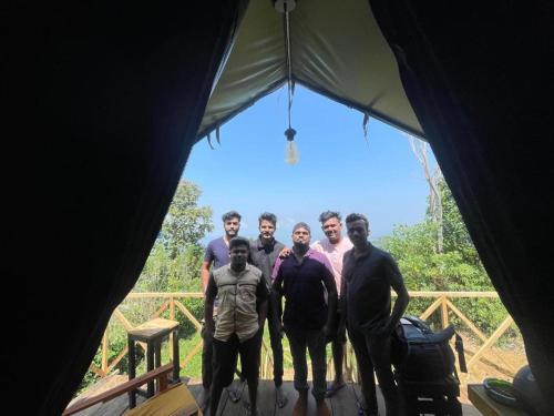 a group of men standing inside of a tent at Peacock Hill Glamp in Gampola
