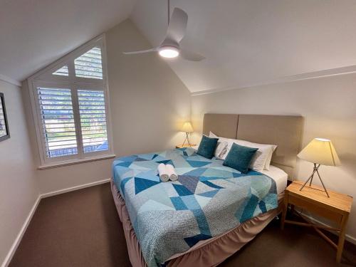 a bedroom with a bed with a teddy bear on it at Escape to 67 at Cape View in Broadwater