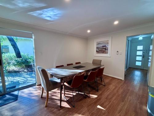 a dining room with a table and chairs at Escape to 67 at Cape View in Broadwater