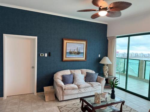 a living room with a couch and a ceiling fan at Hotel Colon Salinas 2 bedroom Oceanview apartment in Salinas