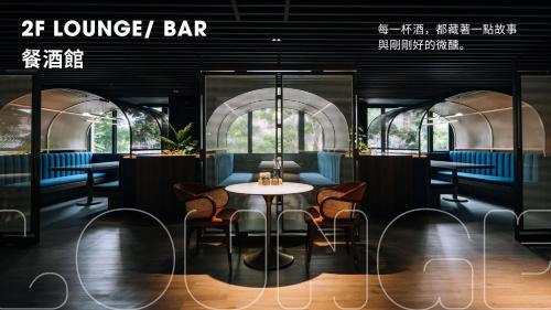 a restaurant with a table and chairs and a bar at Talmud Hotel Classic Taiwan Boulevard in Taichung