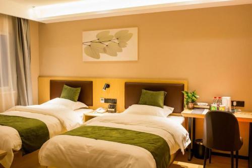 a hotel room with two beds and a desk at GreenTree Inn Express Chuzhou Langya District Government Chuhe Road in Chuzhou