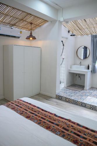 a bathroom with a sink and a mirror at Coconut Breeze Villa 3 in Haad Chao Phao