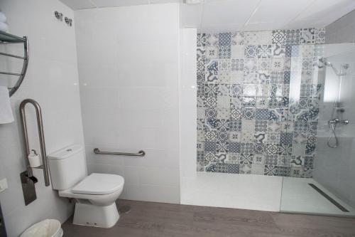 a bathroom with a toilet and a shower at Hostal Boutique Bajamar in Nerja