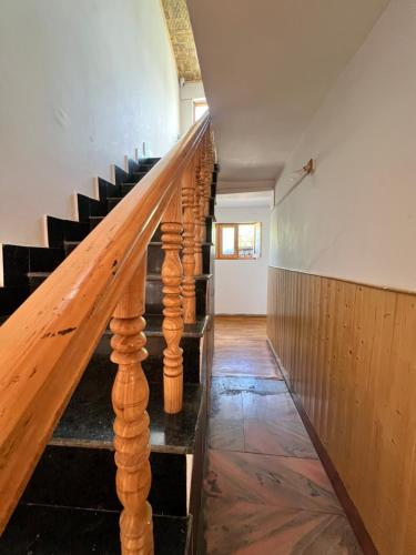 a staircase in a house with wooden railings at Sky Land guest house in Leh