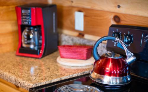 a red tea kettle sitting on top of a stove at Journey's End in Gatlinburg