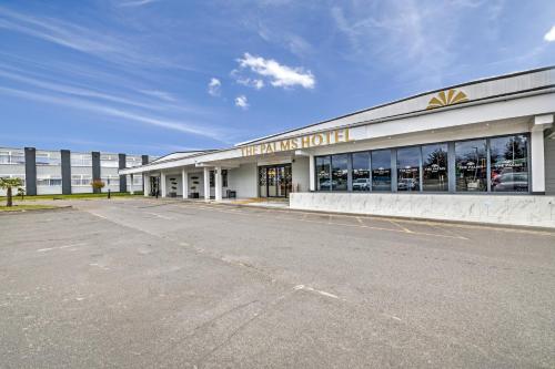 a building with a sign on the front of it at Palms Hotel & Retreat By Palette London Romford in Hornchurch
