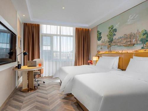 a hotel room with two beds and a desk at Vienna Hotel Beijing Changping Science and Technology Park in Beijing