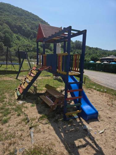 a playground with a slide in a park at Vikendica, Bazen, Šedrvan, Rafting na Uni, Quad in Bihać