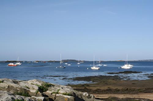 a group of boats floating in the water at Gîte Vue Imprenable Mer in Lanmodez