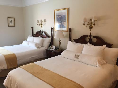 a hotel room with two beds with white pillows at Beresford Arms in San Francisco