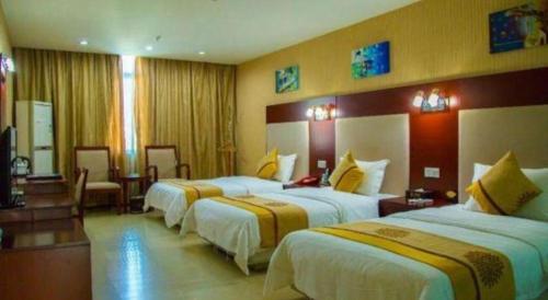 Postel nebo postele na pokoji v ubytování Wanxiang Hotel