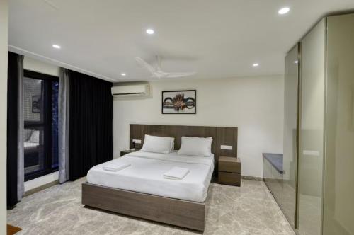 a bedroom with a large white bed in a room at Royal escape in Gurgaon