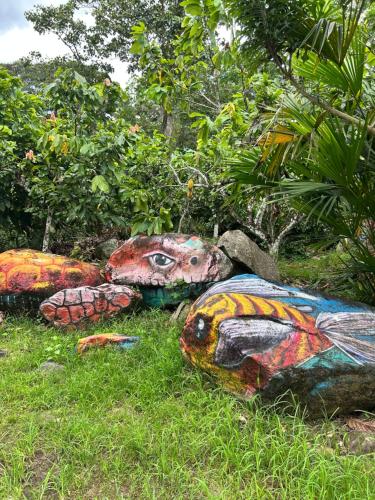 three painted turtle statues sitting in the grass at Finca Turística Las Margaritas in Rivera
