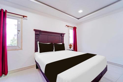 Ένα ή περισσότερα κρεβάτια σε δωμάτιο στο Hotel O Malabar Plaza