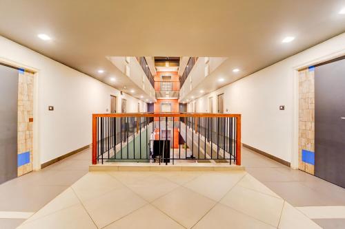 a hallway with a staircase in a building at Super Townhouse Jyoti Mahal Road Rayagada in Rāyagada