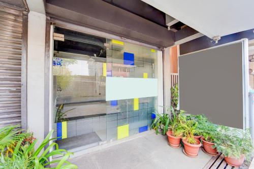 a building with a window with plants in pots at Super Townhouse Jyoti Mahal Road Rayagada in Rāyagada