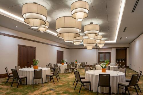 a conference room with tables and chairs and chandeliers at The Tallison Hotel, a Tribute Portfolio Hotel in Carmel