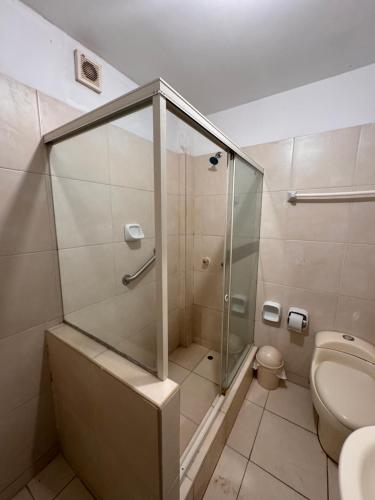 a bathroom with a shower and a toilet at Mango & Apartments in Tumbes