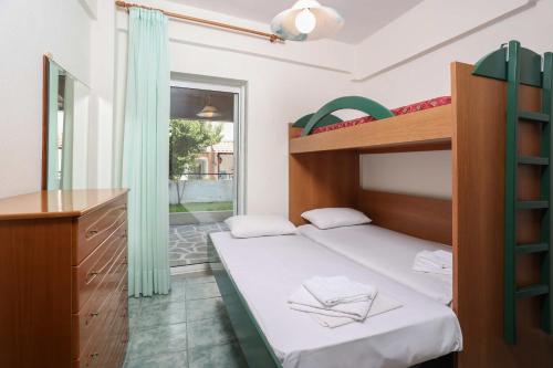 En eller flere senge i et værelse på Villa Garden