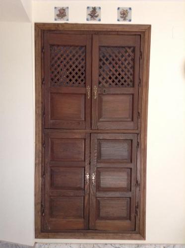 una puerta de madera en la esquina de una habitación en Apartment Gloria en Cáceres