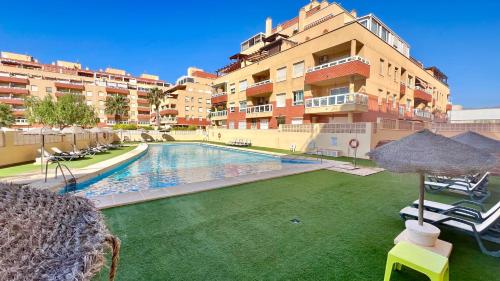 a swimming pool in front of a building at MAR AZUL Playa y Piscina 80 metros de la playa in Roquetas de Mar
