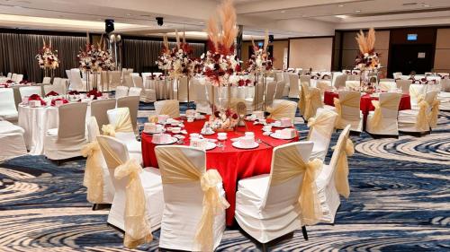 a banquet hall with white tables and white chairs at Holiday Inn Singapore Atrium by IHG in Singapore