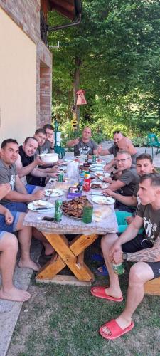 a group of people sitting around a picnic table at Vikendica, Bazen, Šedrvan, Rafting na Uni, Quad in Bihać