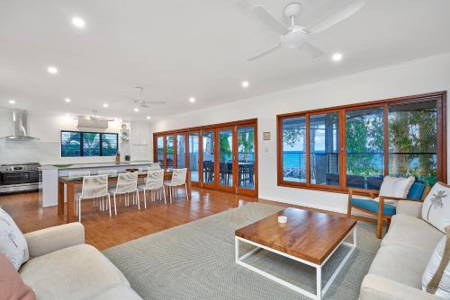 a living room with a couch and a table at Seascape Luxury Beachfront House in Clifton Beach