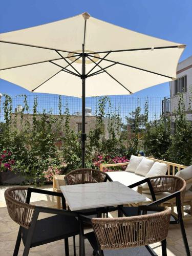 a table and chairs with an umbrella on a patio at Spiti Anastasia in Kathikas