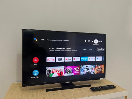 a flat screen tv sitting on a table with a remote control at Family Serenity Apartments in Orikum