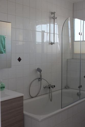 a bathroom with a shower and a bath tub at Ferienwohnung in Wesel