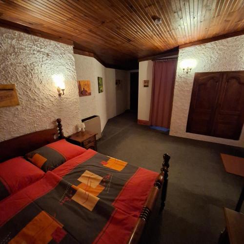 une chambre avec un lit et un plafond en bois dans l'établissement Linda Gorges du Caramy, à Tourves