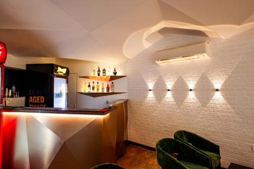 a bar in a restaurant with a white brick wall at Spree Manor Hotel in Aurangabad
