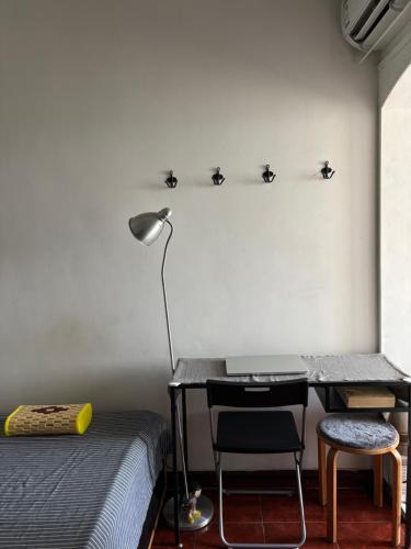 a bedroom with a desk and a bed and a lamp at Books&Bed Close to the Lake in Hangzhou