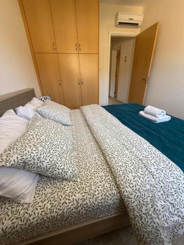 a bed with two pillows on it in a room at Modern Comfort & Sea View - Aphrodite Gardens Pissouri in Pissouri
