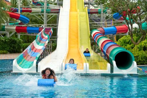 two girls in the water on a water slide at Wyndham Grand Phu Quoc in Phu Quoc