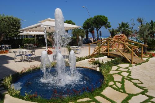 a water fountain in a park with a slide at Hotel Costa Verde in Tortoreto Lido