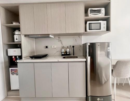 マンダウエ・シティにあるJTower Residences Heart of Mandaue steps from SM JMallの冷蔵庫と電子レンジを備えた小さなキッチン