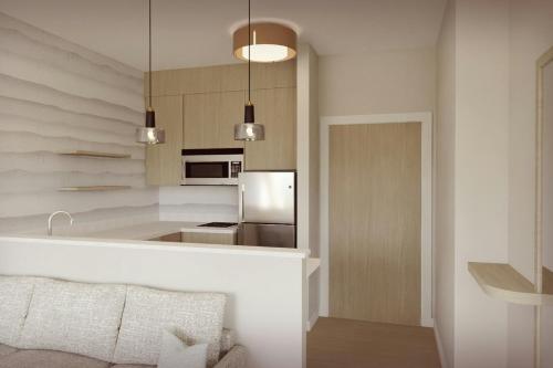 a kitchen with a refrigerator and a counter top at Residence Inn by Marriott Melville in Melville